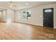 Bright, open living area with wood flooring, a ceiling fan, and a view of the front yard at 3146 Captains Cove Ln, Lincolnton, NC 28092