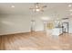 Open living space with wood floors, stainless steel appliances, and access to the outdoor patio at 3146 Captains Cove Ln, Lincolnton, NC 28092