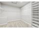 Spacious walk-in closet with white shelving and carpeted floor at 3146 Captains Cove Ln, Lincolnton, NC 28092