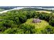 Aerial view of a secluded home surrounded by lush greenery and a sparkling lake at 3678 Rankin Rd, Concord, NC 28027