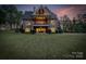 Expansive backyard view of a brick home with a large balcony overlooking the lush lawn at 3678 Rankin Rd, Concord, NC 28027