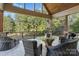 This back porch offers a serene view of the backyard and a covered outdoor seating area at 3678 Rankin Rd, Concord, NC 28027