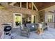 This back porch offers an outdoor kitchen, seating, and a serene view of the backyard at 3678 Rankin Rd, Concord, NC 28027