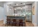 This bar area features a refrigerator, granite countertop, wine rack, and wooden stools at 3678 Rankin Rd, Concord, NC 28027