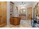 This bathroom features a wooden bathtub and vanity with wood cabinetry and travertine floors at 3678 Rankin Rd, Concord, NC 28027