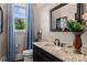 Powder room featuring granite countertops, framed mirror, and decorative accents at 3678 Rankin Rd, Concord, NC 28027