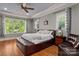 This bedroom features a ceiling fan, natural lighting and a cozy, comfortable aesthetic at 3678 Rankin Rd, Concord, NC 28027