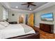 This bedroom features hardwood floors, access to the bath and stairway, and a mounted TV at 3678 Rankin Rd, Concord, NC 28027