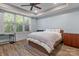 This comfortable bedroom offers a large window with backyard view and stylish hardwood floors at 3678 Rankin Rd, Concord, NC 28027