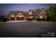 Stunning stone and brick home featuring a spacious three-car garage and manicured landscaping at 3678 Rankin Rd, Concord, NC 28027