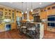 Charming kitchen with custom wood cabinets, stainless steel appliances, and a stone-accented island at 3678 Rankin Rd, Concord, NC 28027