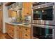Gourmet kitchen featuring a gas cooktop, double ovens, wood cabinets, and custom tile backsplash at 3678 Rankin Rd, Concord, NC 28027