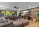 This living room features a wood accent wall, a sectional couch, and glass doors to the backyard at 3678 Rankin Rd, Concord, NC 28027