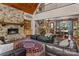 Cozy living room featuring a stone fireplace, leather furniture, and views of the dining room and foyer at 3678 Rankin Rd, Concord, NC 28027