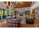 Inviting living room boasts a stone fireplace, wood ceiling, and lots of natural light at 3678 Rankin Rd, Concord, NC 28027