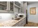 This wet bar features granite countertops, modern appliances, and wine rack above sink at 3678 Rankin Rd, Concord, NC 28027