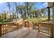 Enjoy the outdoors on this wooden deck overlooking a lush backyard and a charming shed at 108 W Maryland Ave, Bessemer City, NC 28016