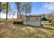 The back of the home features neutral siding, a walkout basement, and a wooden deck at 108 W Maryland Ave, Bessemer City, NC 28016