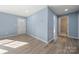 Inviting hallway featuring wood floors, a decorative front door, and access to a tiled bathroom at 108 W Maryland Ave, Bessemer City, NC 28016