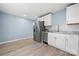 Bright kitchen features stainless steel appliances, white cabinets and stone countertops at 108 W Maryland Ave, Bessemer City, NC 28016