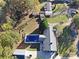 Aerial view of home with fenced pool, surrounding trees, and outbuildings at 115 Turner St, Lincolnton, NC 28092