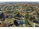 Aerial view of a wooded neighborhood with homes and green spaces in autumn at 115 Turner St, Lincolnton, NC 28092
