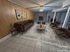 Spacious basement area with wood paneling, rustic-style rug, brick fireplace, and comfortable seating at 115 Turner St, Lincolnton, NC 28092