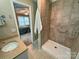 Bathroom featuring tiled shower with grab bar, granite countertop vanity, and tiled floors at 115 Turner St, Lincolnton, NC 28092