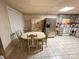 Inviting dining area with a table and chairs, stainless steel refrigerator, and light tile floors at 115 Turner St, Lincolnton, NC 28092