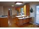 Eat-in kitchen featuring wood cabinets, tile countertops, and an outside access door at 115 Turner St, Lincolnton, NC 28092