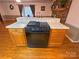 Eat-in kitchen featuring cooktop stove, bar, and wood cabinets at 115 Turner St, Lincolnton, NC 28092