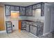The kitchen features decorative cabinets, tile backsplash, a double basin sink, and tile flooring at 115 Turner St, Lincolnton, NC 28092