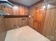 Utility room with wood cabinets and paneling, perfect for storage and laundry needs at 115 Turner St, Lincolnton, NC 28092