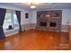 Spacious living room featuring a brick fireplace, hardwood floors, and abundant natural light at 115 Turner St, Lincolnton, NC 28092