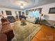 Spacious living room featuring hardwood floors, a decorative rug, and a cozy seating area at 115 Turner St, Lincolnton, NC 28092