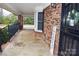 Side porch of a brick home featuring an iron railing at 115 Turner St, Lincolnton, NC 28092