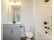 Clean bathroom features white tile bathtub and gray vanity with undermount sink at 145 Halite Way, Waxhaw, NC 28173