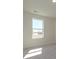 Empty bedroom with carpet and a single window overlooking front yard at 145 Halite Way, Waxhaw, NC 28173