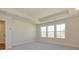 Bright bedroom featuring neutral walls, tray ceiling, carpet flooring and three windows providing natural light at 145 Halite Way, Waxhaw, NC 28173