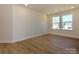 Empty bedroom features hardwood floors and two windows at 145 Halite Way, Waxhaw, NC 28173