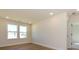 Bright, empty bedroom features hardwood floors and two windows at 145 Halite Way, Waxhaw, NC 28173
