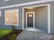 The entryway has a gray door and a small landscaped area to the side at 145 Halite Way, Waxhaw, NC 28173