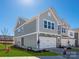 Exterior view of a two-story home featuring a two-car garage, green siding, and a manicured lawn at 145 Halite Way, Waxhaw, NC 28173