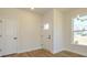 Bright foyer featuring wood-look floors, a window, and a white door leading to another room at 145 Halite Way, Waxhaw, NC 28173