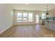 Open-concept living space with wood-look floors, abundant natural light, and seamless flow to the kitchen at 145 Halite Way, Waxhaw, NC 28173