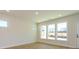 Bright and spacious living room with wood-look floors, large windows, and a view of the neighborhood at 145 Halite Way, Waxhaw, NC 28173