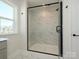Marble tiled shower with black trim, black door hardware and a shower seat at 145 Halite Way, Waxhaw, NC 28173