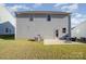 A view of the home's backyard featuring a patio and well-maintained lawn and gray siding at 2507 Andes Dr, Statesville, NC 28625