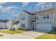 Charming two-story home with a well-manicured lawn and attached garage and a blue front door at 2507 Andes Dr, Statesville, NC 28625