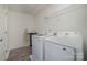 Functional laundry room with modern washer and dryer, featuring overhead shelving at 2507 Andes Dr, Statesville, NC 28625